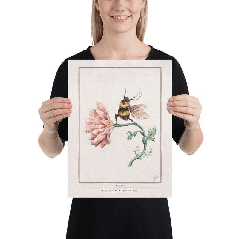 Holding up a poster of a yoga bee illustration