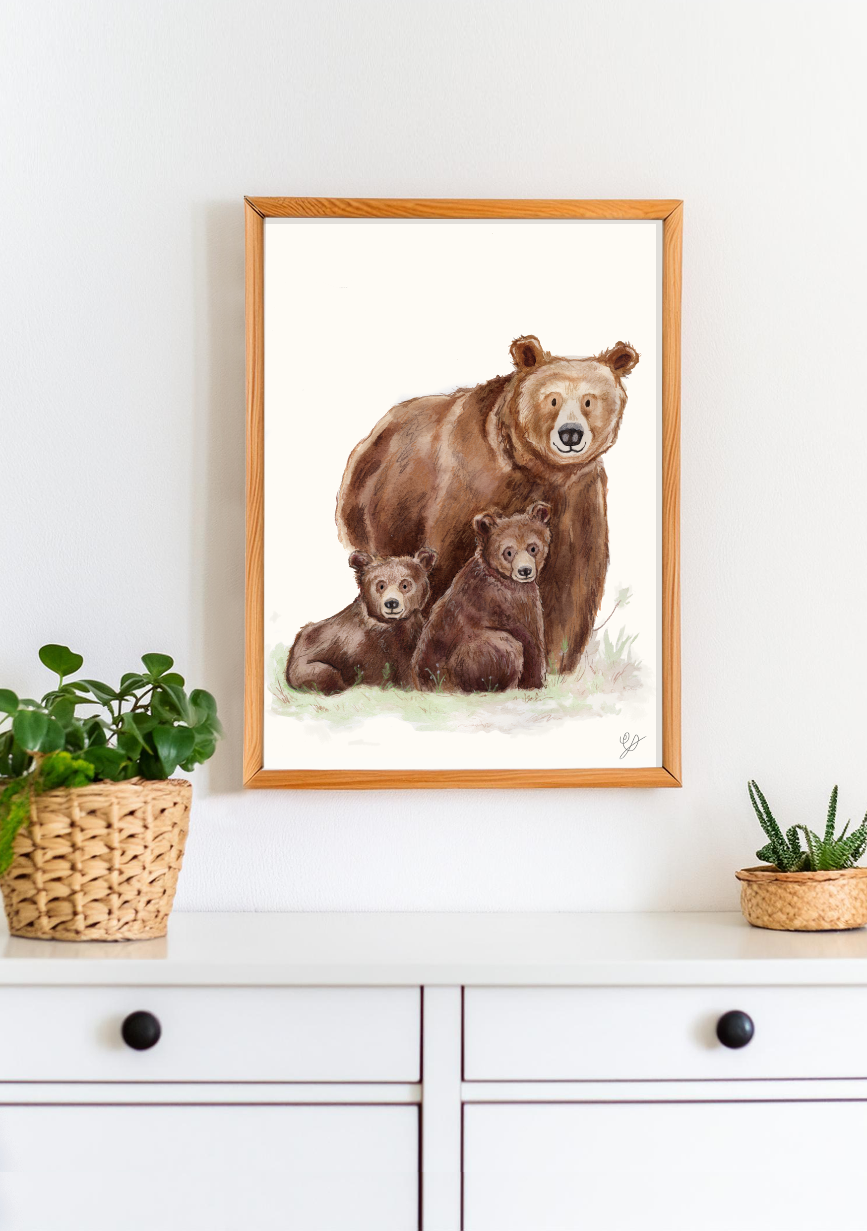 A framed print of watercolor bears on a white wall